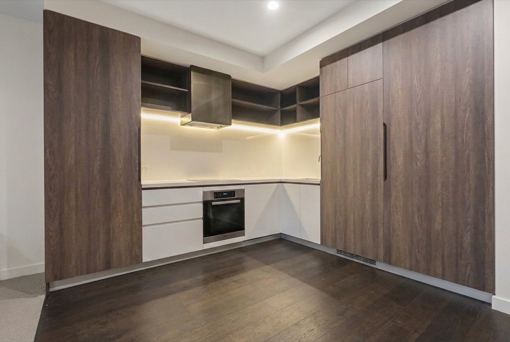 The same kitchen after ProMyPhoto declutter — benches and floor cleared, the room reads clean